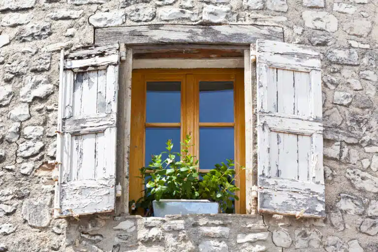 house facade with white shutters in france